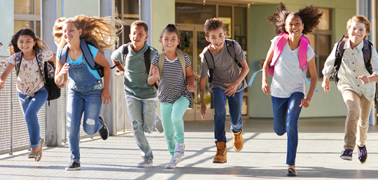 Children running outside a school